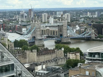 Tower Bridge spanning the Thames, seen from above the surrounding London rooftops