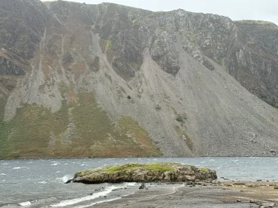 Waves along the rocky shore of Wast Water, beneath steep mountain slopes