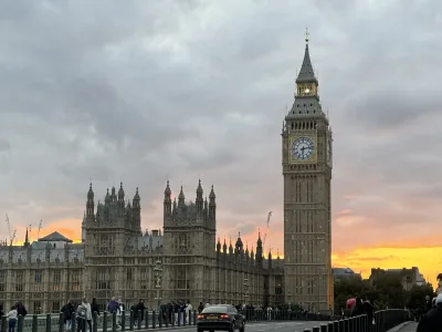 Big Ben and the Houses of Parliament against a glowing sunset, seen from Westminster Bridge