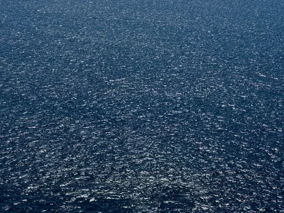 Sunlight glinting across the blue water of the Taiwan Strait